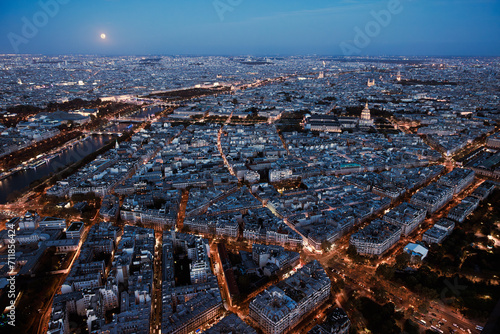 Paris city at night from above. Aerial view from Eiffel tower at blue hour. Panorama skyline after sunset. Full moon night © Girts