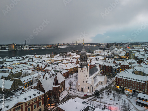 Obraz na płótnie Aerial winter skyline panoramic view of Aalborg covered with snow. Old town with the Budolfi Church (Budolfi Kirke). North Jutland, Denmark
w salonie