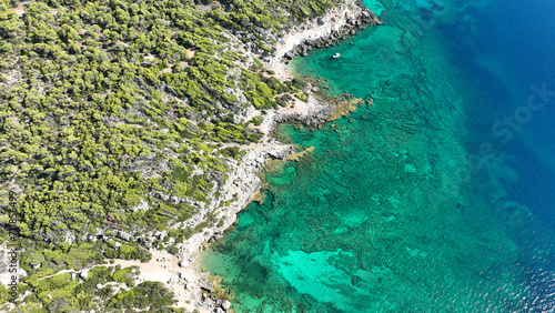 Aerial drone photo of not so famous but paradise secluded sterna beach with crystal clear emerald sea near iconic lake Vouliagmenis, Loutraki, Greece