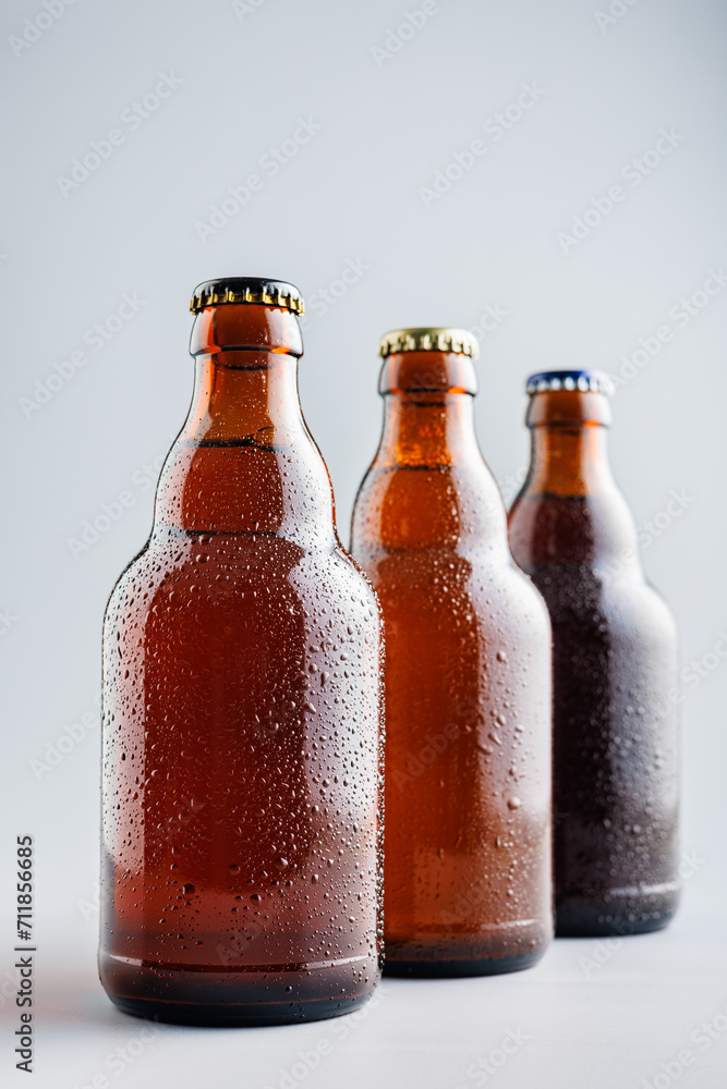 Beer bottle with drops on gray background. Beer bottle with drops on gray background.