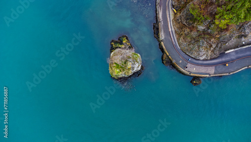 Top down view of Siwash Rock next to a bend in the seawall. Stanley Park, Vancouver, BC, Canada