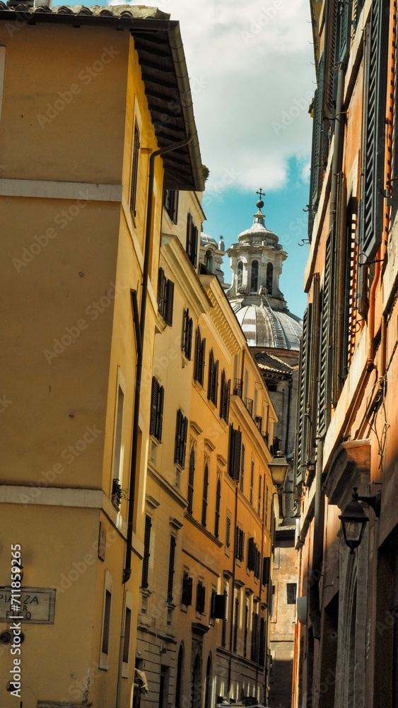 Dramatic light in the streets of Rome city with church dome