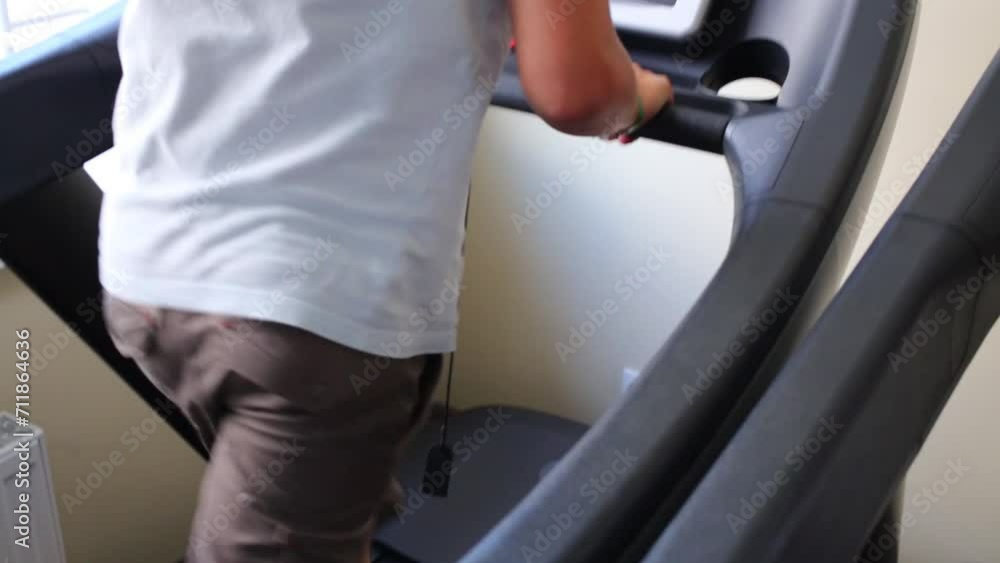 Boy teen training on treadmill in fitness center. Boy teen training on treadmill in fitness center.