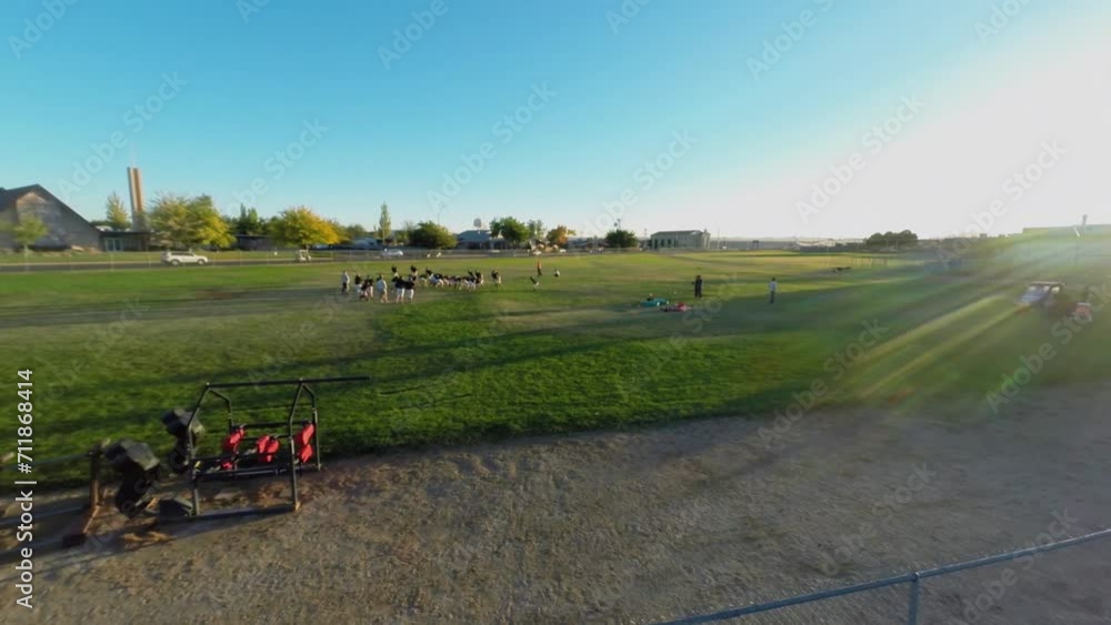 Sportsmen train on football field at autumn sunny day. Sportsmen train on football field at autumn sunny day.