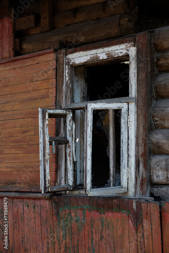 A dilapidated wooden house with rickety walls and broken windows.