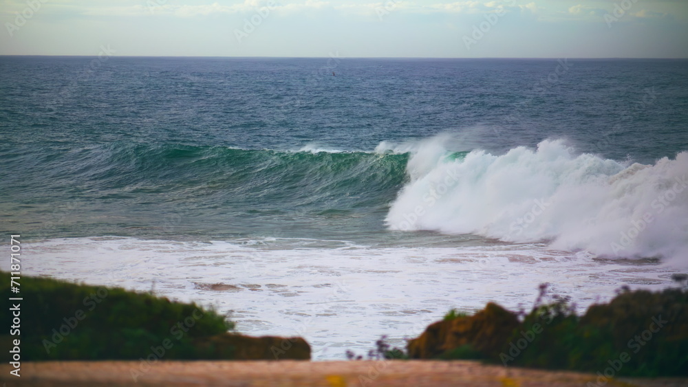 Ocean waves rolling shore in slow motion. Stormy dark sea breaking shallow reef Ocean waves rolling shore in slow motion. Stormy dark sea breaking shallow reef