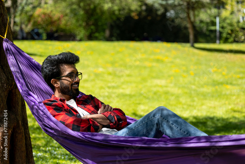 Young hindu man feeling relaxed and happy in the park