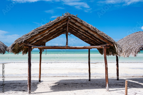 Fototapeta Naklejka Na Ścianę i Meble -  Natural and tropical hut on the beach Caribbean Ocean Front, desert beach whit hammock on a beach in Holbox Island, Mexico