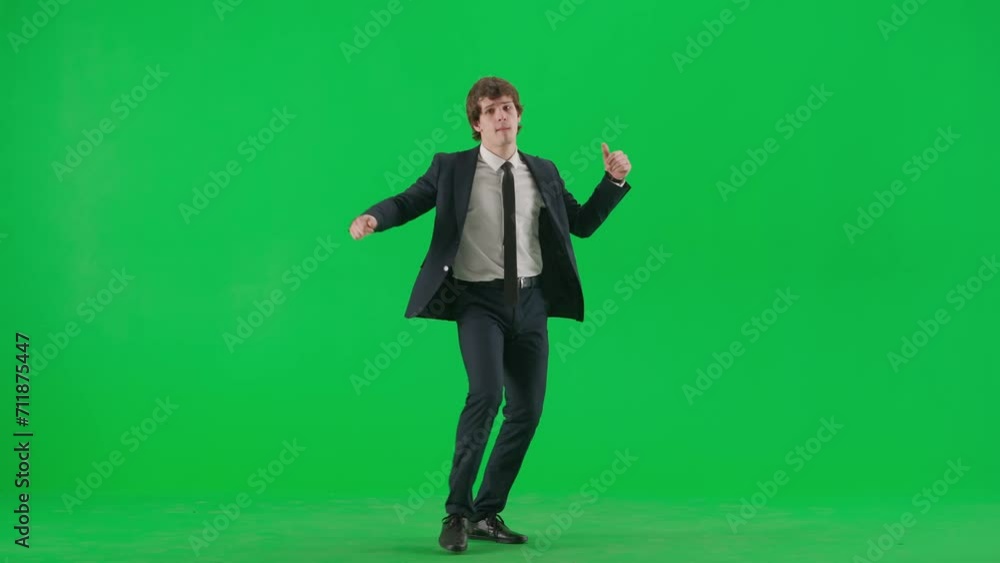 Portrait of male model in suit on chroma key green screen. Handsome young businessman in trendy suit walking and dancing coolly at the camera. Portrait of male model in suit on chroma key green screen. Handsome young businessman in trendy suit walking and dancing coolly at the camera.