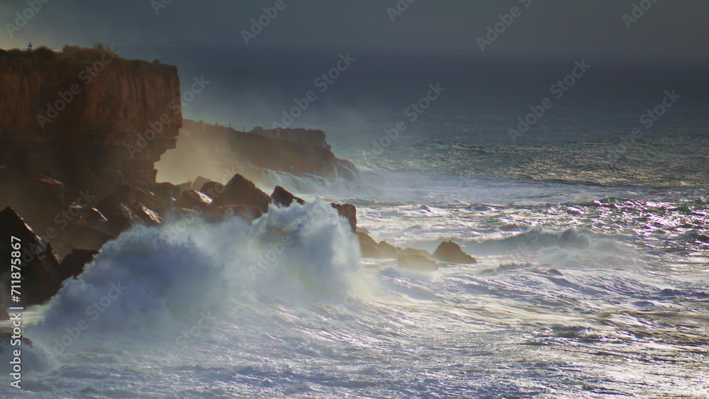 Powerful ocean hitting cliffs on stormy day. Dramatic waves breaking rocks make