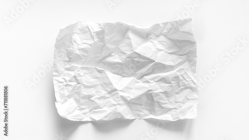 A heavily crumpled sheet of white paper close-up with copy space. Crumpled sheet of A4 paper on a white background. Mockup for inscriptions, words, graphics. Abstract white background made of paper. © nieriss