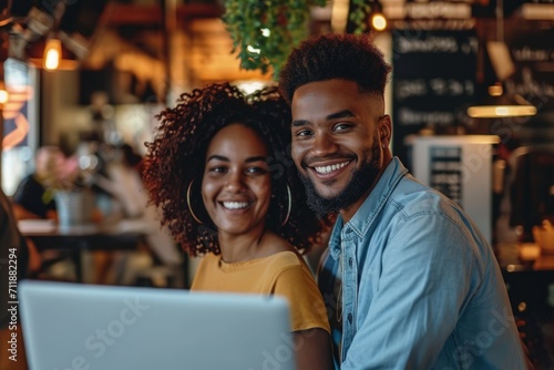 Man and Woman Smiling at Laptop