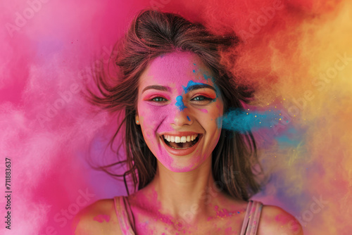 Happy adult girl with paint on face celebrating Holi festival in India. Portrait of smiling young woman on colorful powder background. Concept of color, party, fun, people