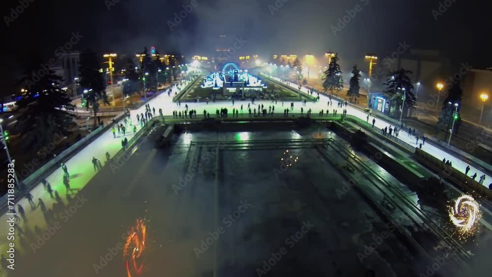 Many smoke from fireworks on ice rink with people at winter Many smoke from fireworks on ice rink with people at winter