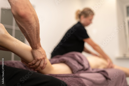 Masseur Providing a Deep Tissue Leg Massage at Spa