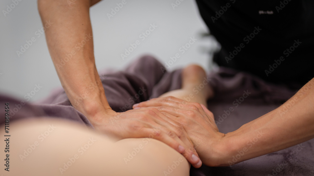 Masseur Providing a Deep Tissue Leg Massage at Spa