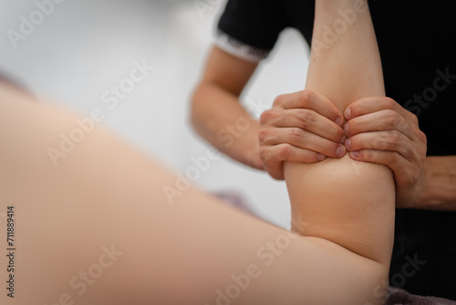 Masseur Providing a Deep Tissue Leg Massage at Spa