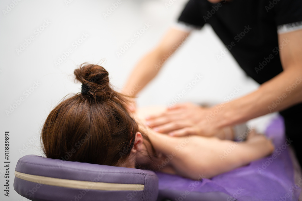 Professional Masseur Performing Back Massage at Spa