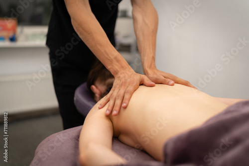 Expert Masseuse Giving a Focused Leg Massage