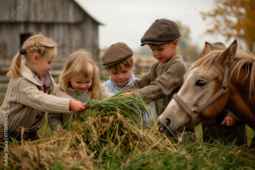 Obraz na płótnie Five children feeding a horse some grass at Old World Wisconsin in Eagle, WI w salonie