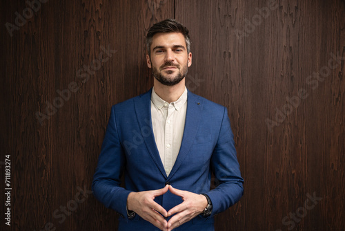 Portrait of handsome respectful businessman standing and looking to the camera. photo