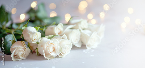 Serene bouquet of white roses against a gentle, luminous backdrop.