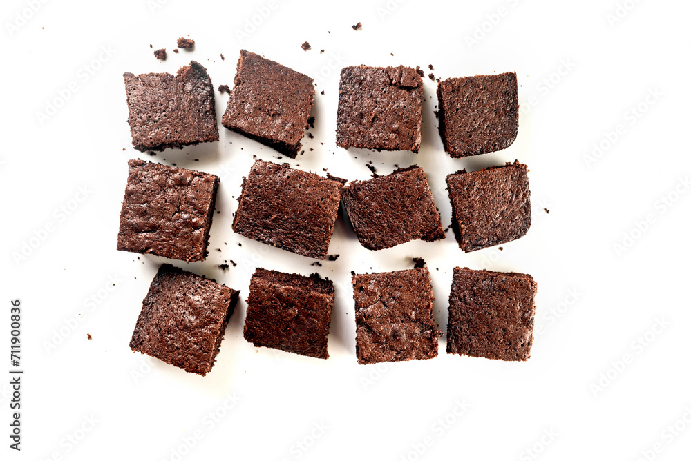 Many pieces of fresh chocolate brownie on a white table. Homemade delicious chocolate pie Many pieces of fresh chocolate brownie on a white table. Homemade delicious chocolate pie