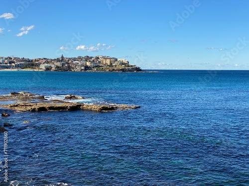 Coast of the ocean. View of the city in the distance surrounded by water. Landscape and shore. Australia.
