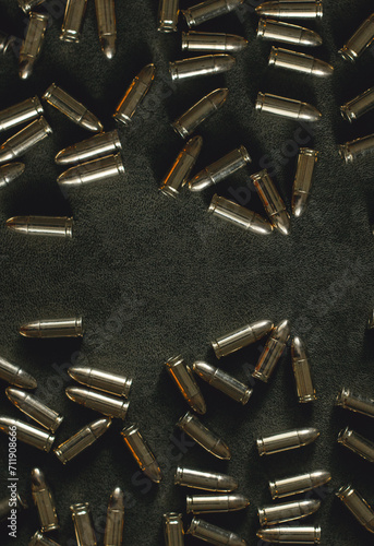 bullets for a combat pistol 9 mm gold color lies on a dark  background top view close-up