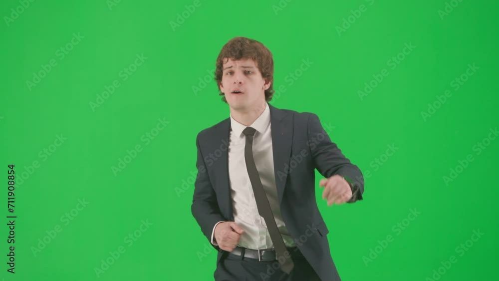 Portrait of male model in suit on chroma key green screen background. Stylish young businessman in trendy suit walking and dancing at camera. Portrait of male model in suit on chroma key green screen background. Stylish young businessman in trendy suit walking and dancing at camera.