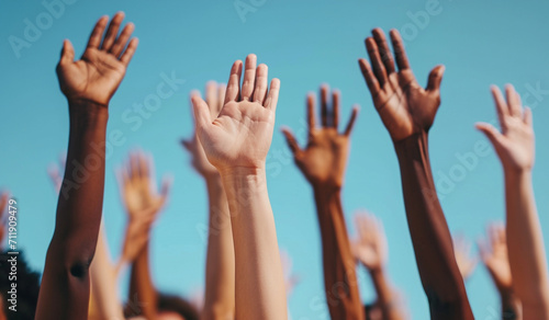 Multi ethnic, multi racial group of hands raised up. Diversity concept.