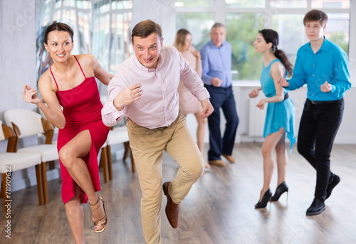 Fototapeta Naklejka Na Ścianę i Meble -  Adult couple dancing and practicing in dance class