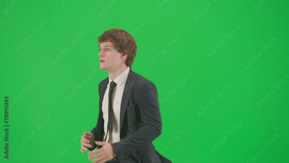 Profile view of male model in suit isolated on chroma key green screen background. Positive young businessman in blue suit running fast. Profile view of male model in suit isolated on chroma key green screen background. Positive young businessman in blue suit running fast.