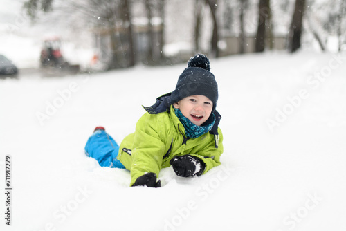 Happy Little Kid is Playing in Snow