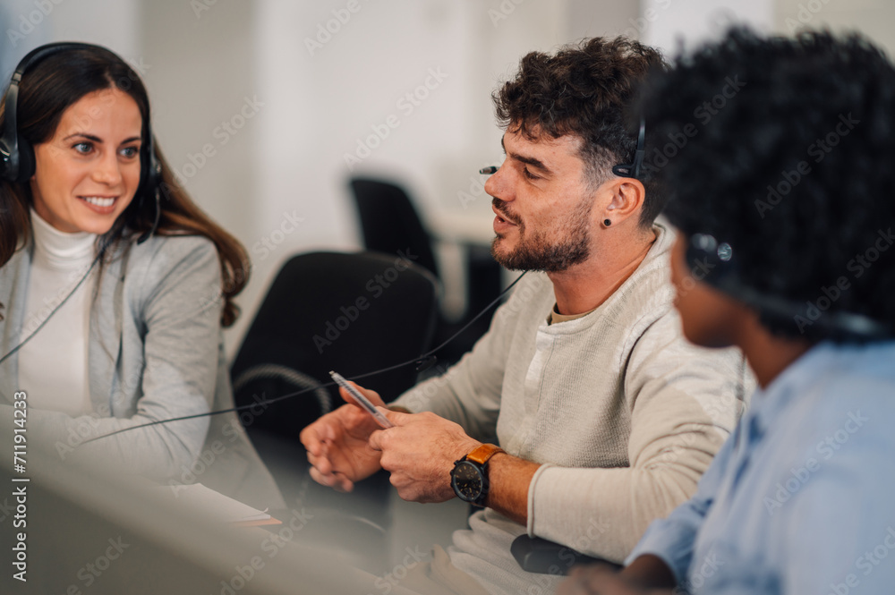 Male call center agent answering incoming calls with a headset Male call center agent answering incoming calls with a headset