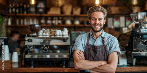Confident male barista with arms crossed standing in a coffee shop