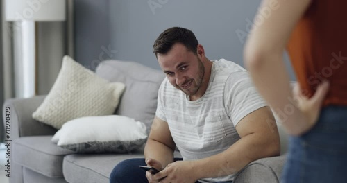 Infidelity, couple and caught cheating on phone with fight, conflict or argument about social media. Divorce, breakup or affair with man and woman on sofa in home living room for online communication