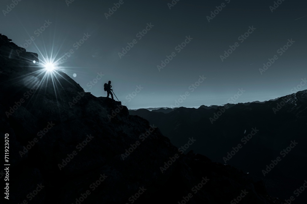 Mountaineer on rocky ledge with sun star, in the background South Tyrolean mountains, Naturns, South Tyrol, Italy, Europe Mountaineer on rocky ledge with sun star, in the background South Tyrolean mountains, Naturns, South Tyrol, Italy, Europe