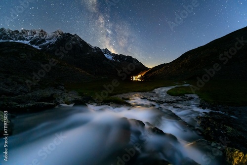 Mountain stream with Winnebachsee hut and Winnebach peaks with starry sky and Milky Way, Sellrain, Innsbruck, Tyrol, Austria, Europe photo