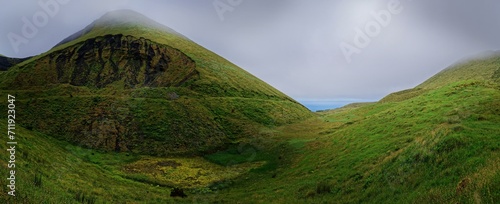 Green overgrown volcanic landscape and cones in the fog, Estradas dos Lagoas, Madalena, Pico, Azores, Portugal, Europe photo
