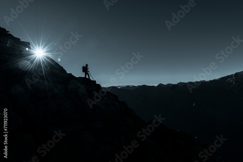 Mountaineer on rocky ledge with sun star, in the background South Tyrolean mountains, Naturns, South Tyrol, Italy, Europe photo