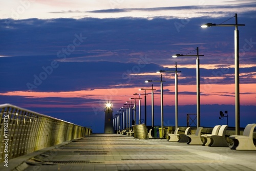 Sunrise with lighthouse at the harbour pier in Porto Maurizio, Imperia, Liguria, Italy, Europe photo