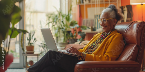 an elderly woman using her laptop photo