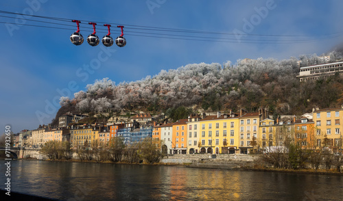 Cityscape of Grenoble with Bastille hill and famous cable car in winter, France