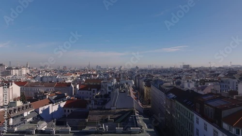 Wallpaper Mural Forwards fly above buildings in residential urban neighborhood in large city. Low flight above roofs with chimneys and antennas. Vienna, Austria Torontodigital.ca