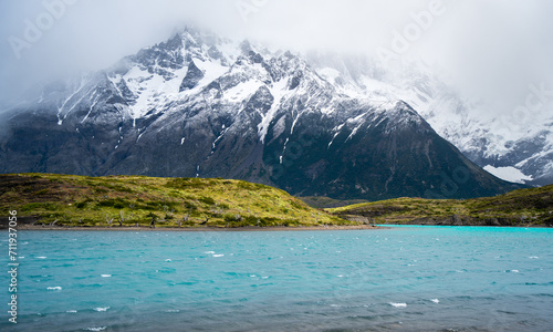 blue lake and snow mountains under mist