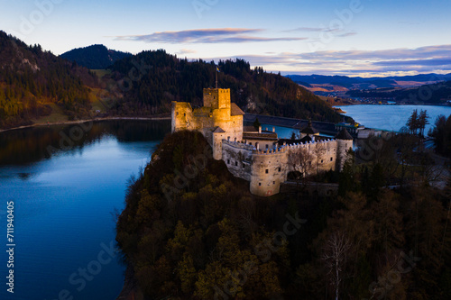 Historical view of Nedzica castle near Chorshtynskoe reservoir at twilight
