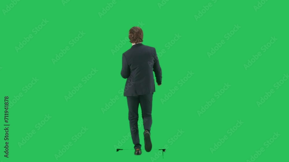 Back shot of male model in suit isolated on chroma key green screen background. Young businessman office worker in suit walking and slowly dancing. Back shot of male model in suit isolated on chroma key green screen background. Young businessman office worker in suit walking and slowly dancing.