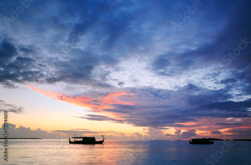 Dhoni traditional maldivian boat at sunset, Maldives