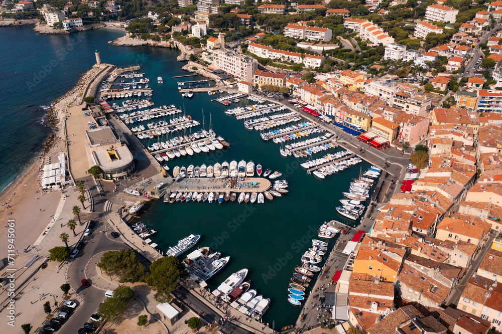 Picturesque aerial view of Cassis cityscape on Mediterranean coast with marina on sunny autumn day, Southern France.